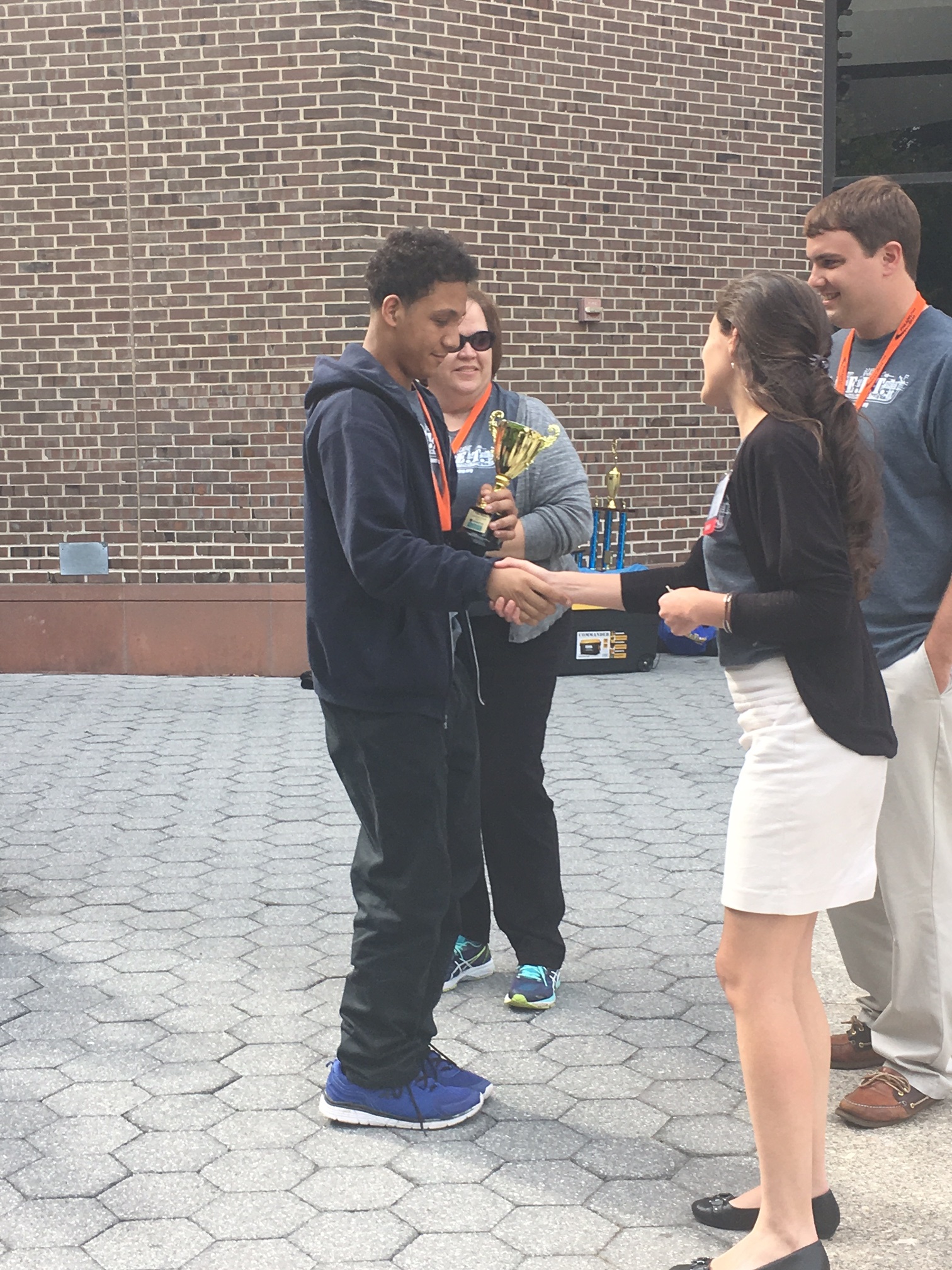 A triumphant engineer receives a well-earned trophy.